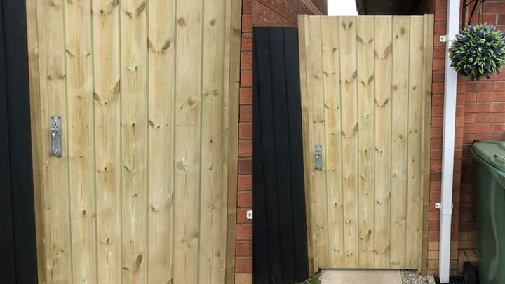 Full-framed tongue and grooved timber gates, one close up and one set into a brick wall beside a black fence