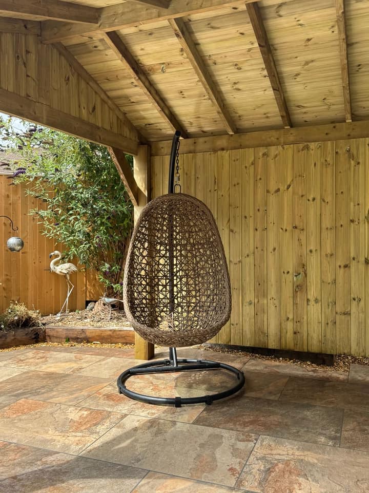 A hanging egg chair beneath the Kensington gazebo roof