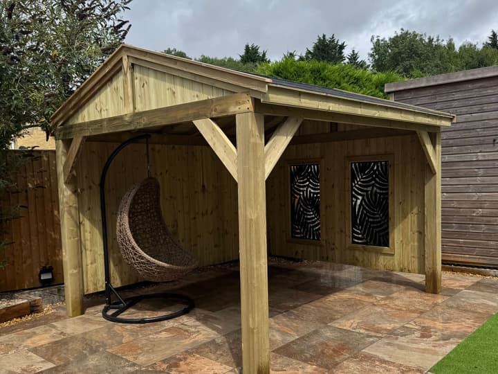 The Kensington gazebo from the front, with the egg chair and decorative panels on the tiled patio